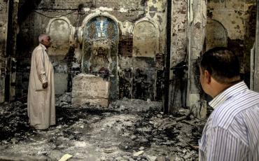 Members of the congregation inspecting the burnt altar of St. John's Church in Assuit, Upper Egypt, on August 19. Photo: Roger Anis