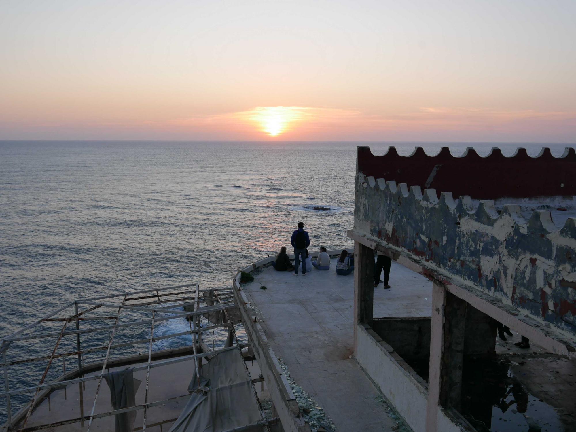 People watch the sunset from a roof terrace in the Mar Kikhal district. Photo: Elena Athina Mieslinger (Instagram: @elena_athina)