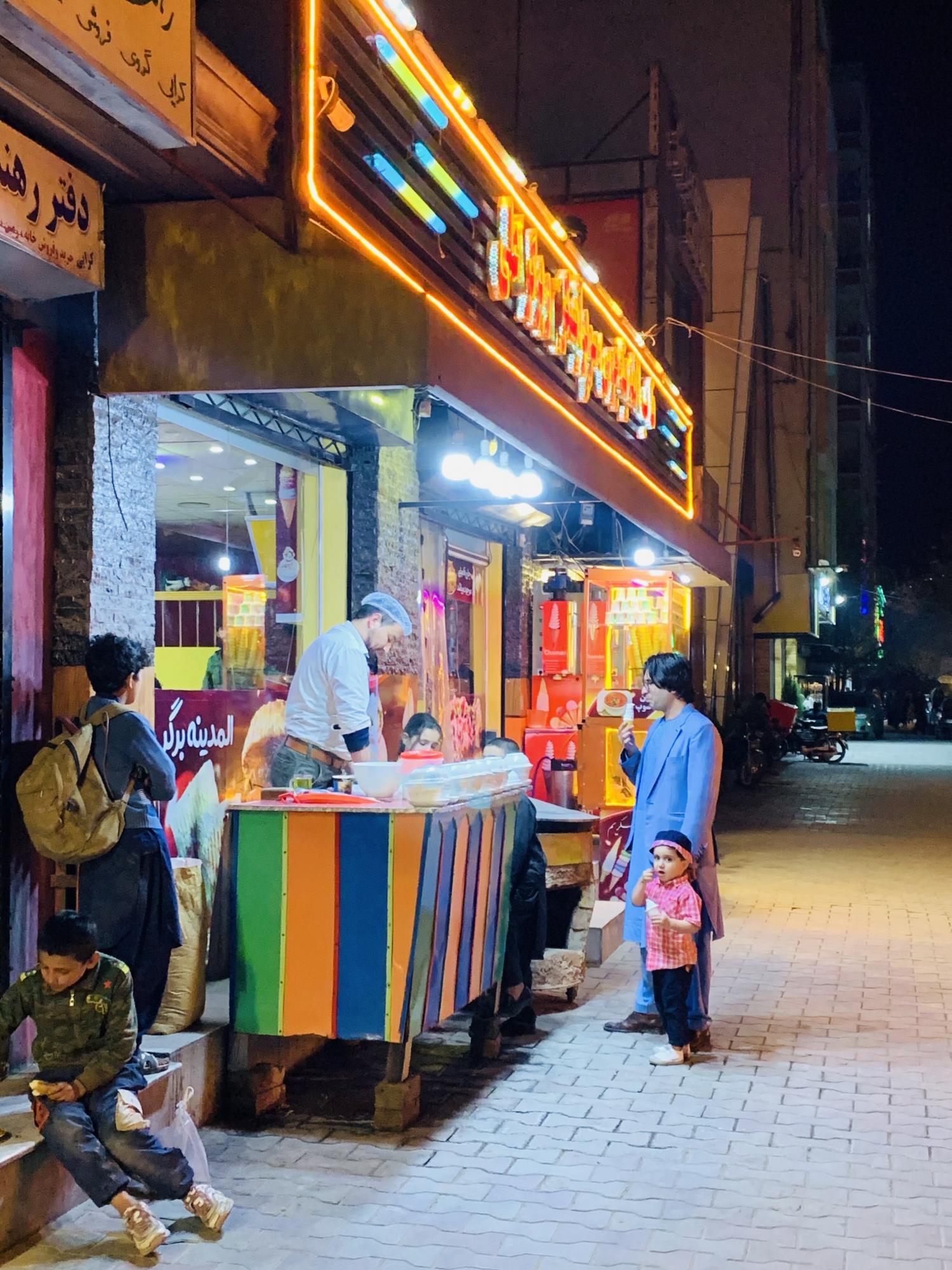 Some children eat an ice cream from a small stand on the street. Photo: Mohammad Asghar Rahimi (Instagram @haji_aimal1)